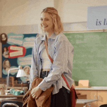 a woman standing in front of a chalkboard that says " is " on it