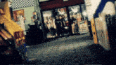 a group of people are standing in front of a store that has a sign that says ' best ' on it