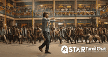 a group of men are dancing in front of a sign that says tamil chat