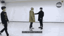 a group of men are dancing in a room .