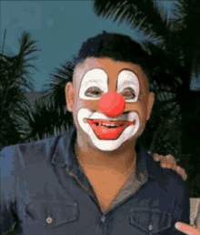 a man is wearing a clown mask and smiling