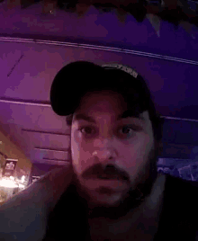 a man with a beard and mustache wearing a black hat with the word storm written on it