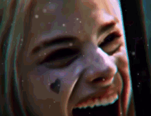 a close up of a woman 's face with blood on her face