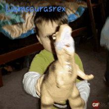 a child is holding a toy dinosaur with the name liamsaurusrex written on the bottom