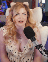 a woman sitting in front of a microphone wearing a cat ear headband