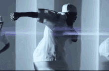 a man in a white shirt and hat is dancing in a room