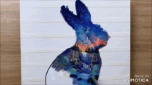 a painting of a rabbit with a waterfall in the background is made in animatica
