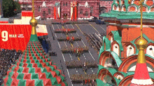 marching soldiers are lined up in front of a red banner that says 9 mar