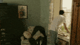 a man looking out of a window in a room