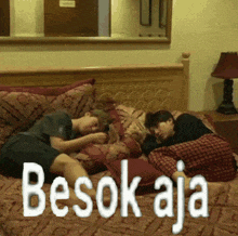 two boys laying on a bed with the words besok aja written on the bottom
