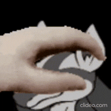 a close up of a person 's hand reaching out towards a cartoon character .