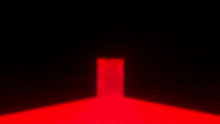 a man in a fur coat is standing in a dark room with a red light