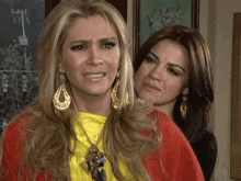 two women are standing next to each other one is crying and the other is smiling