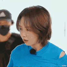 a close up of a woman wearing a blue sweater with the name elleigh on the bottom
