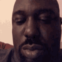a close up of a man 's face with his eyes closed .