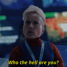 a woman with a lanyard that says " who the hell are you " on it