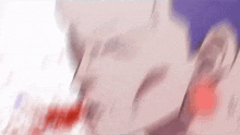 a close up of a person 's face with blood coming out of it 's mouth .