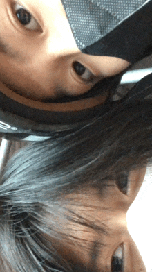 a close up of a person 's face with a reflection of another person