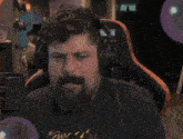 a man with a beard wearing headphones and a t-shirt that says ' when ' on it