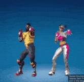 a man and a woman are dancing with their hands in the shape of a heart
