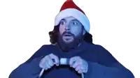 a man with a beard wearing a santa hat is holding a video game controller