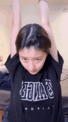 a girl wearing a black shirt that says ' aoi ' on it