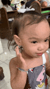 a little girl with a white bow on her hair