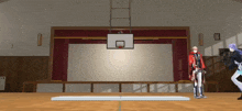 a man in a red jacket stands in front of a basketball court