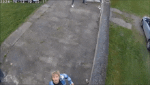 a person in a blue and white plaid shirt is walking down a sidewalk with the date of 2024 on the bottom