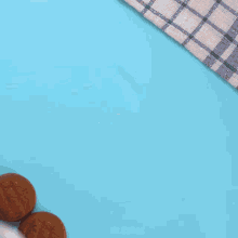 three plastic containers of cookies on a blue surface with the words mr cakes on the bottom right corner