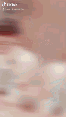 a tiktok video of a man sitting at a table smiling and laughing
