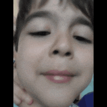 a close up of a child 's face with his eyes closed and his mouth open