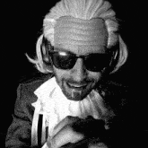 a man with a wig on his head and sunglasses