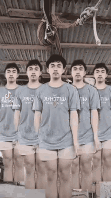 a group of young men are standing in a row wearing t-shirts that say tik tok