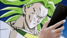 a person is holding a cell phone in front of a dragon ball character