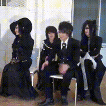 a group of people are sitting in chairs in a room
