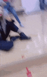 a blurry picture of a person sitting on the floor in a room .