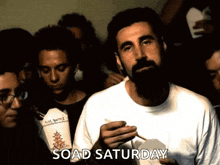 a man with a beard is eating chinese food with the words soad saturday written below him