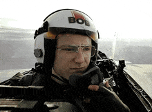 a man wearing a helmet that has bos on it