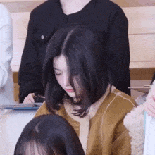 a group of girls are sitting in a classroom .