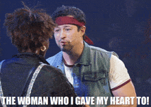 a man with a bandana on his head is talking to a woman with the words " the woman who i gave my heart to " below him
