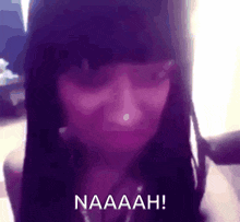 a close up of a woman 's face with the words naaaah in white letters