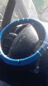 a ford steering wheel with a blue steering cover