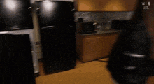 a man is standing in a refrigerator looking inside .