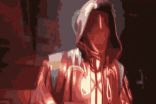 a man in a red hoodie is standing in the dark