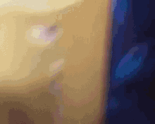 a blurry picture of a person 's face behind a blue curtain