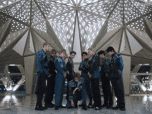a group of young men are posing for a picture in front of a building with the words examples on the bottom