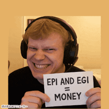 a man wearing headphones holds a sign that says epi and egi = money