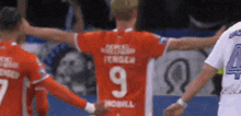 a soccer player wearing a red jersey with the number 9 on it