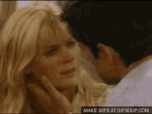 a man is touching a woman 's face in a make gifs at gifsoup.com image